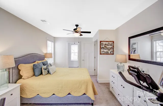 a spacious bedroom with a bed and a lamp