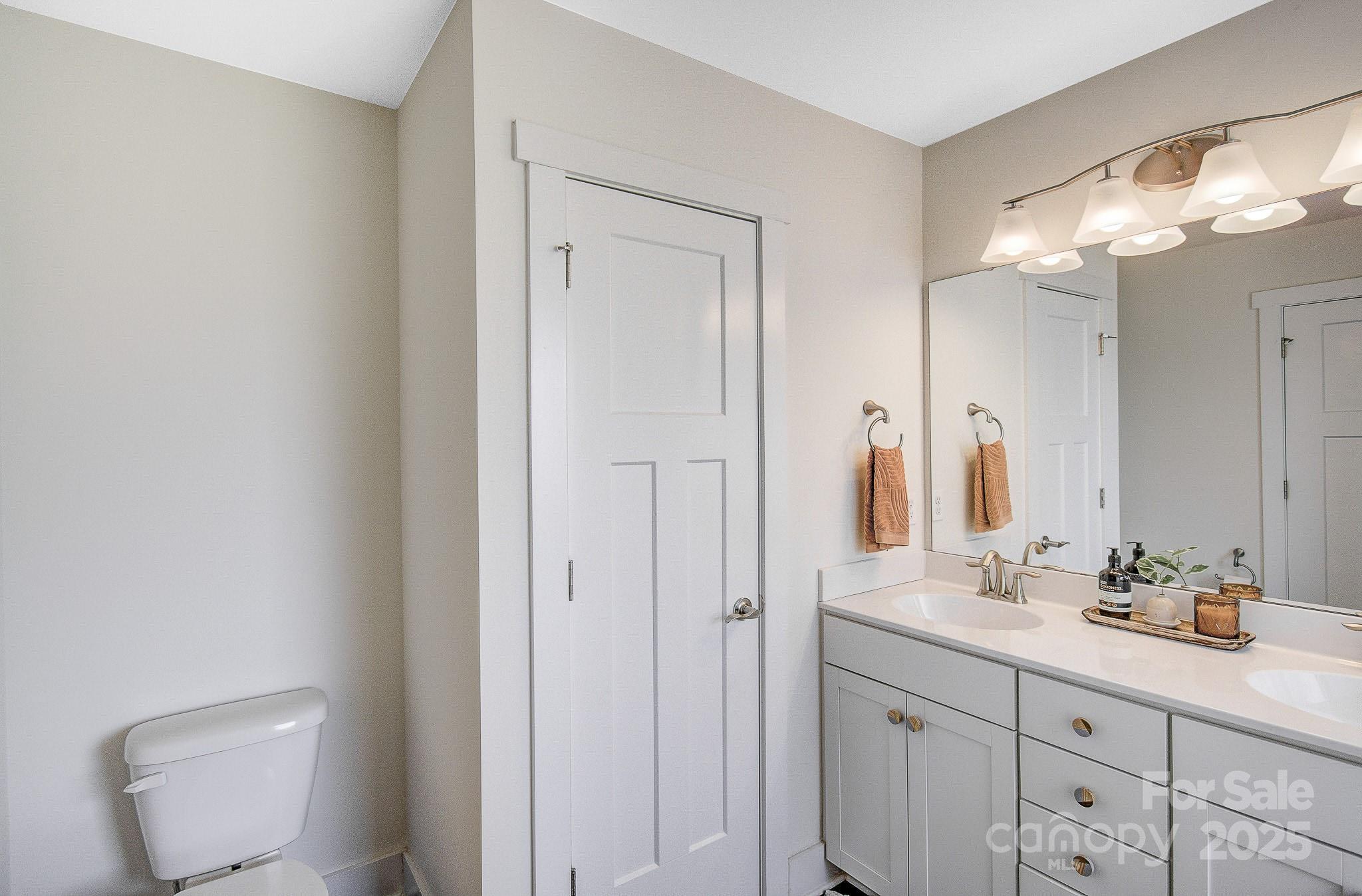 689 Cardwell Lane Fletcher, NC 28732 - Photo 24 of 39 a bathroom with a double vanity sink and a mirror