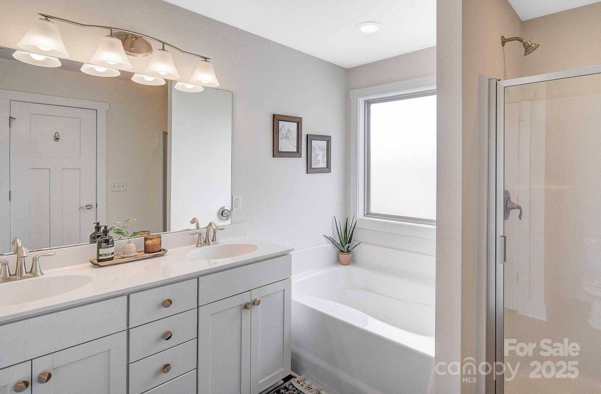 689 Cardwell Lane Fletcher, NC 28732 - Photo 25 of 39 a bathroom with a tub a sink double vanity and shower