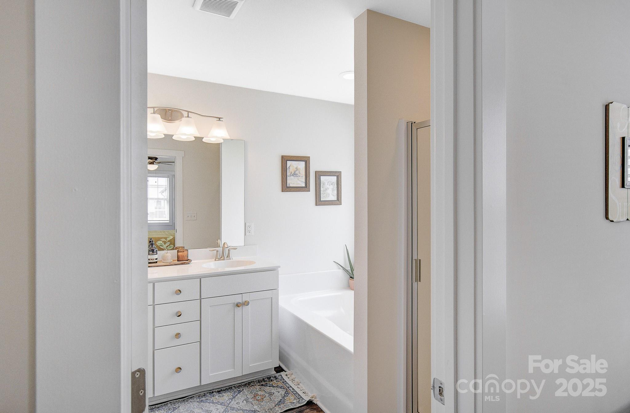 689 Cardwell Lane Fletcher, NC 28732 - Photo 26 of 39 a en suite bathroom with a double vanity sink a mirror and a