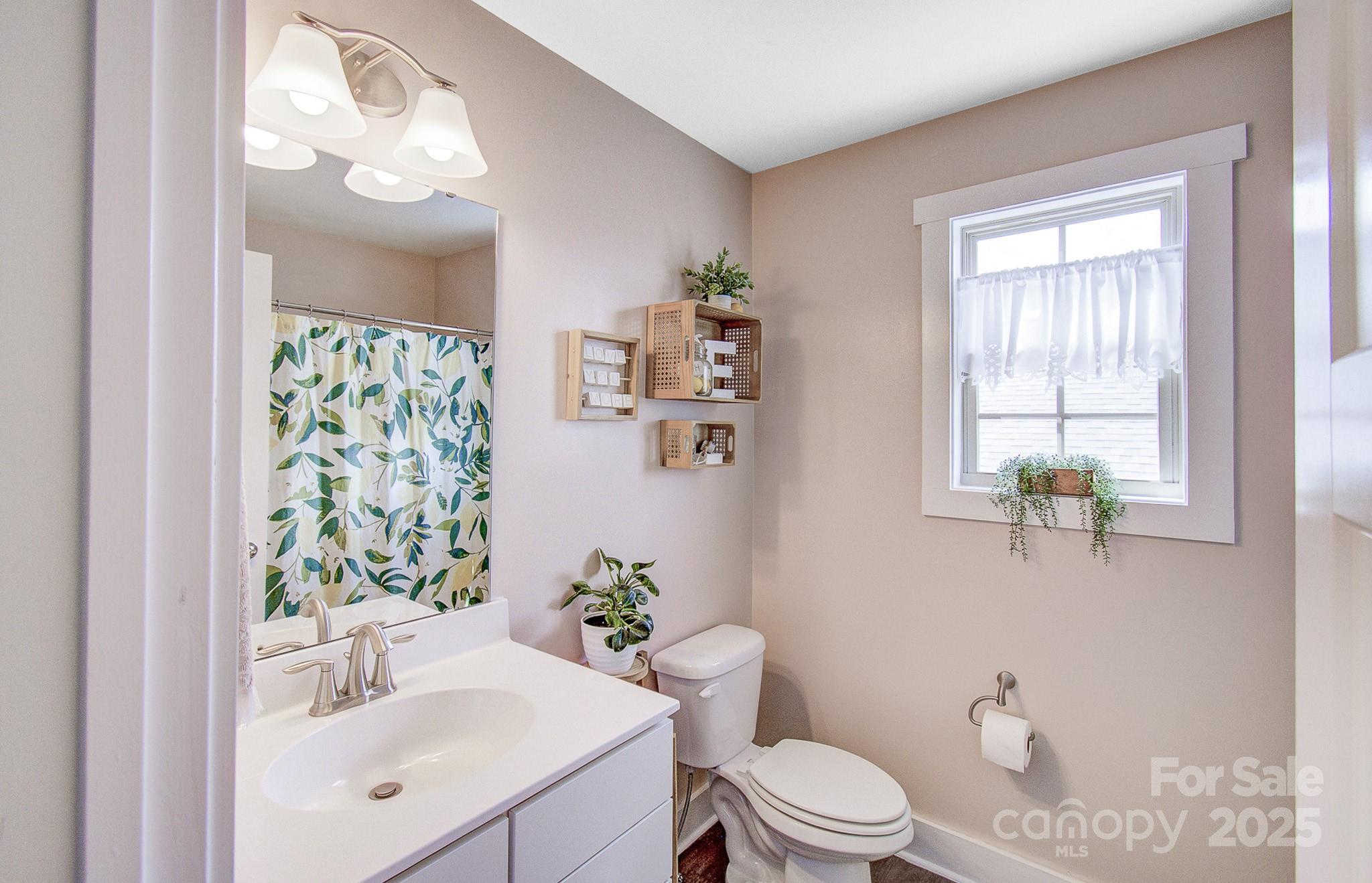 689 Cardwell Lane Fletcher, NC 28732 - Photo 31 of 39 a bathroom with a sink vanity mirror and toilet