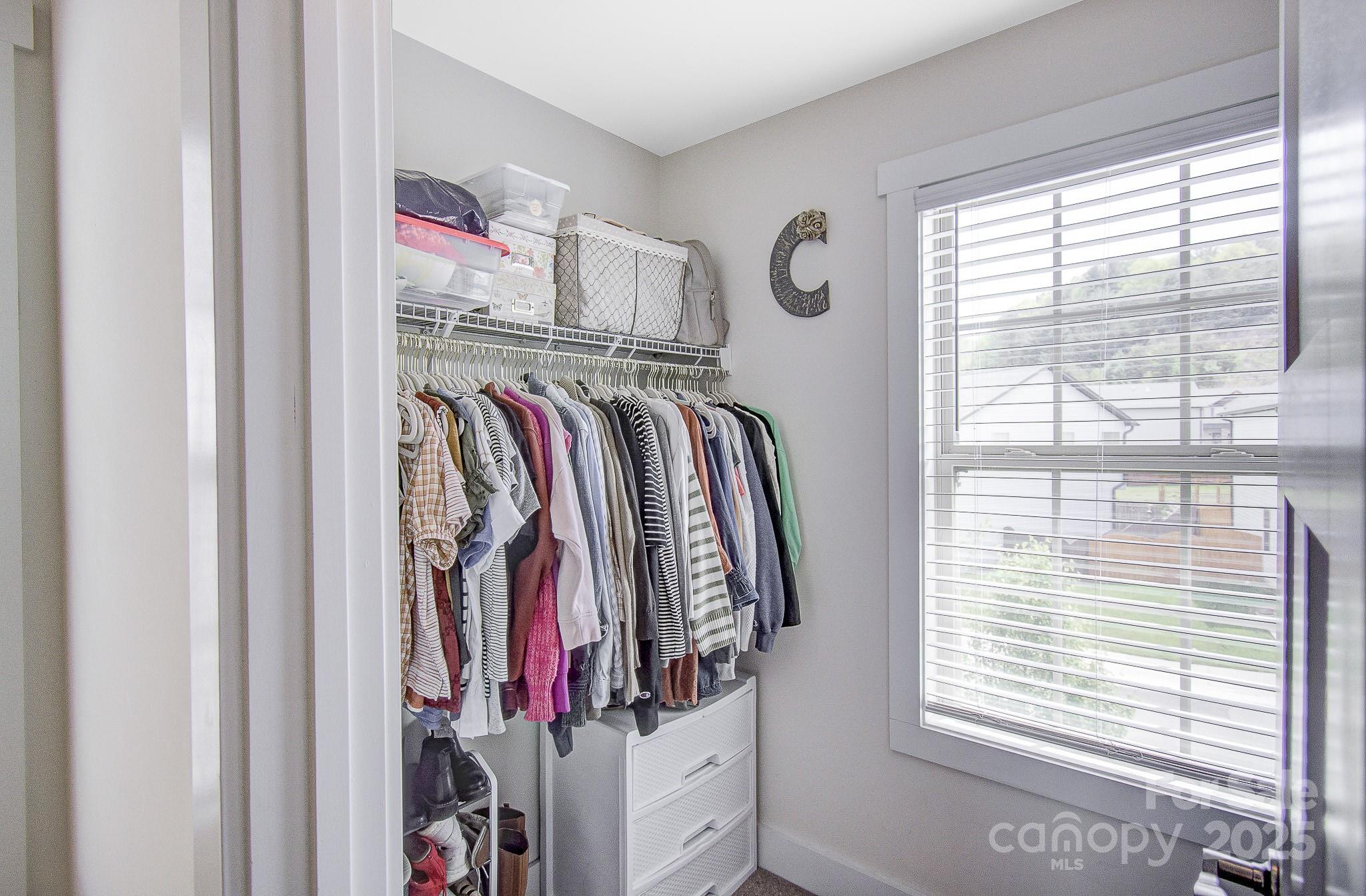 689 Cardwell Lane Fletcher, NC 28732 - Photo 33 of 39 a view of walk in closet with clothes and shoes