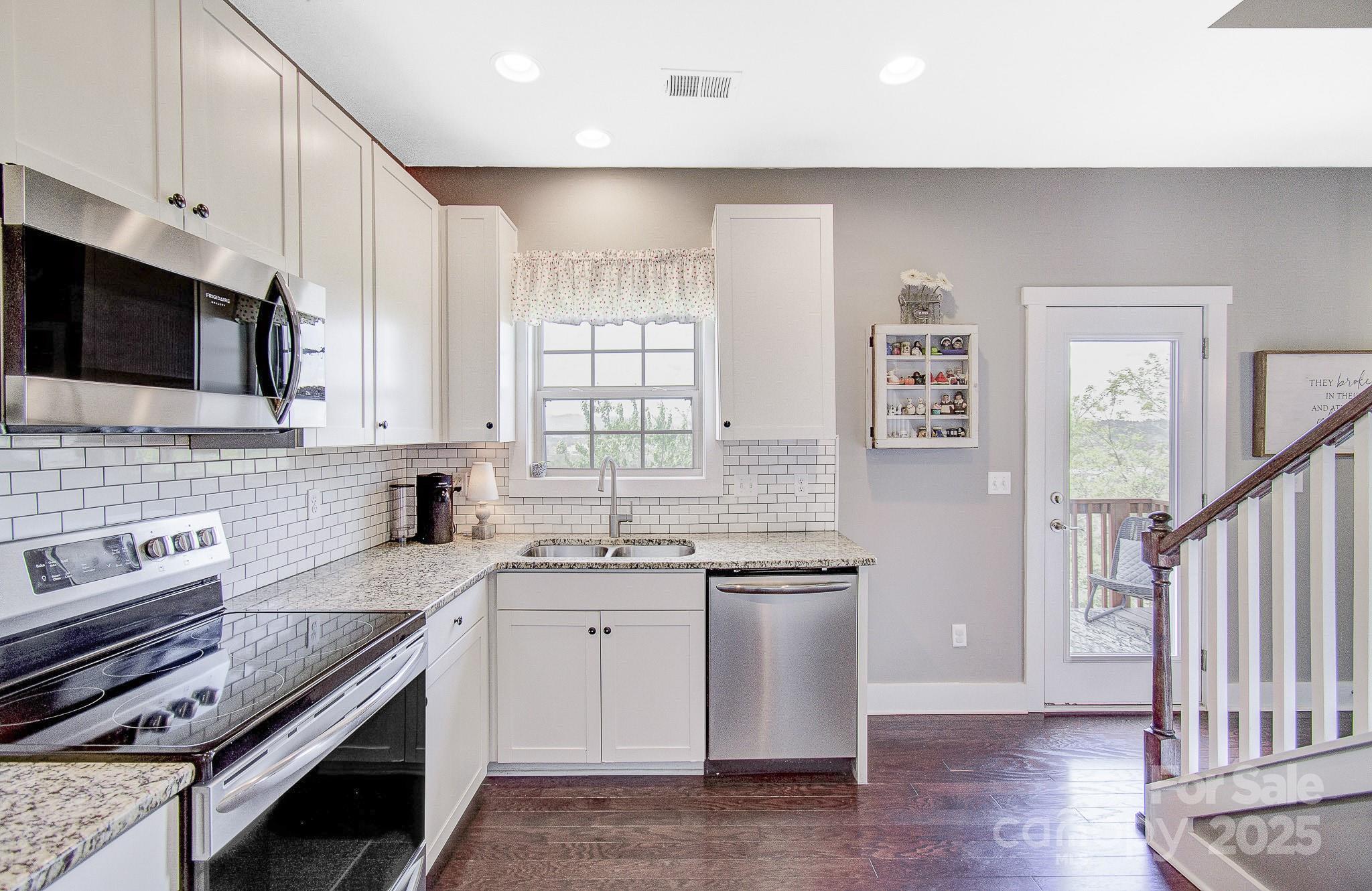 689 Cardwell Lane Fletcher, NC 28732 - Photo 5 of 39 a kitchen with stainless steel appliances a sink stove and cabinets