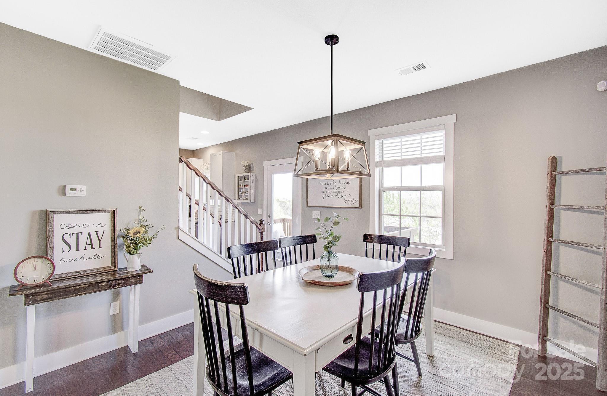 689 Cardwell Lane Fletcher, NC 28732 - Photo 7 of 39 a view of a dining room with furniture window and wooden floor