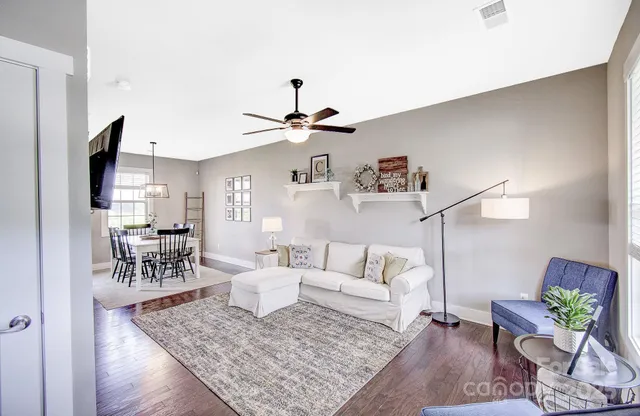 a living room with furniture and wooden floor