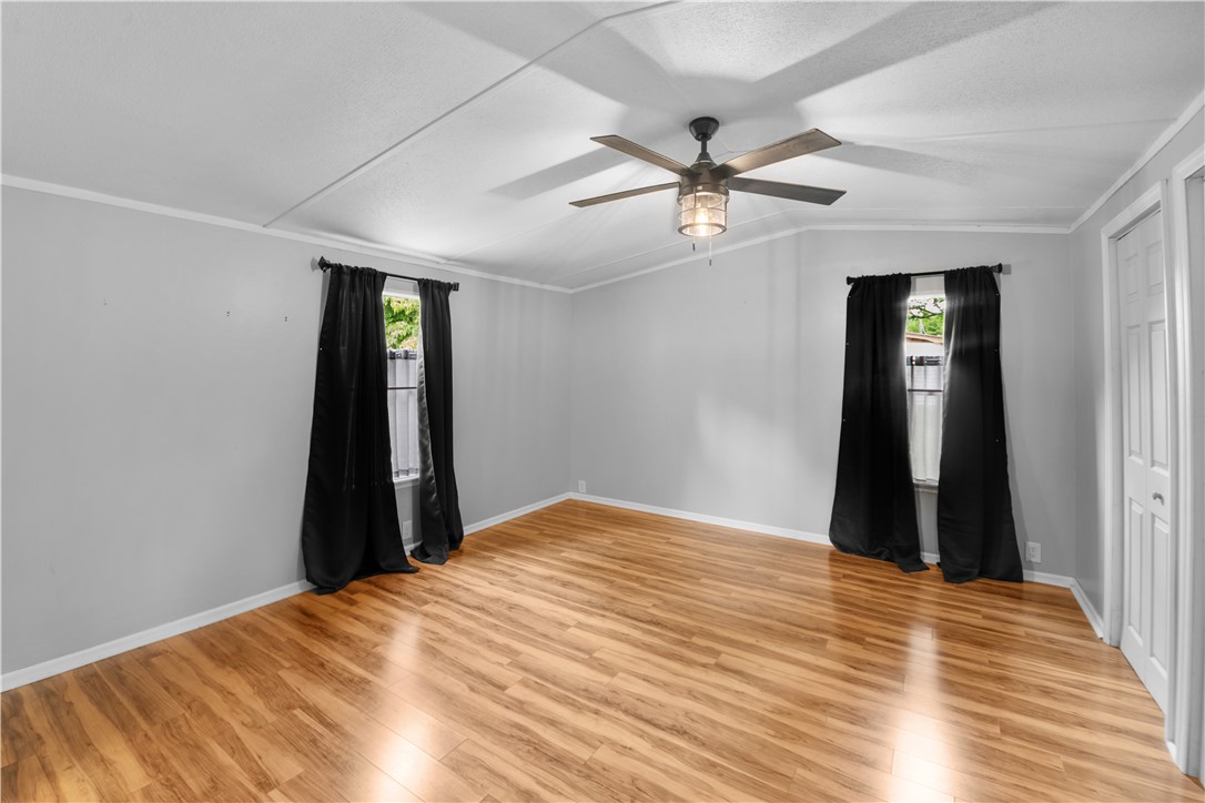 169 West Bagwell Road Liberty, SC 29657 - Photo 18 of 29 Warm wood-toned flooring defines this airy room with a functional ceiling fan.