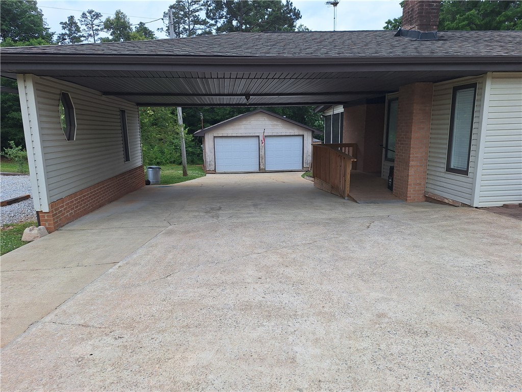 610 Dr Mitchell Road Seneca, SC 29678 - Photo 6 of 47 A spacious concrete driveway offers convenient covered parking and leads to a detached garage.
