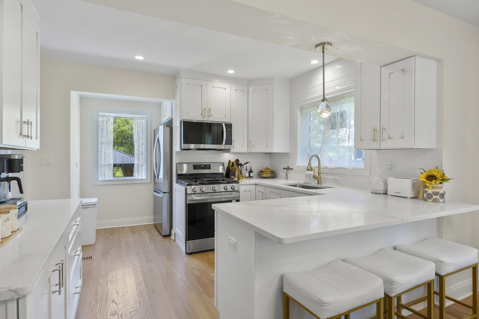 300 Geneva Road Glen Ellyn, IL 60137 - Photo 12 of 41 a kitchen with a sink a stove a refrigerator cabinets and wooden floor