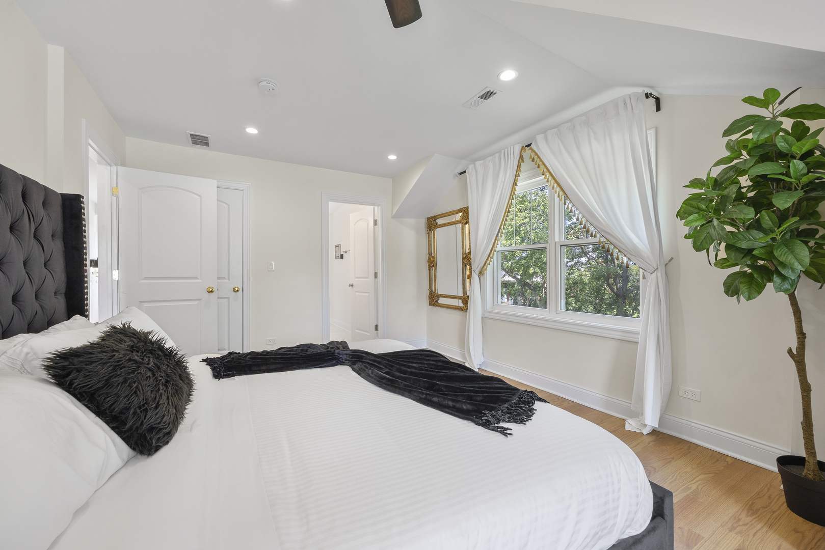 300 Geneva Road Glen Ellyn, IL 60137 - Photo 20 of 41 a bedroom with a bed potted plant and a window