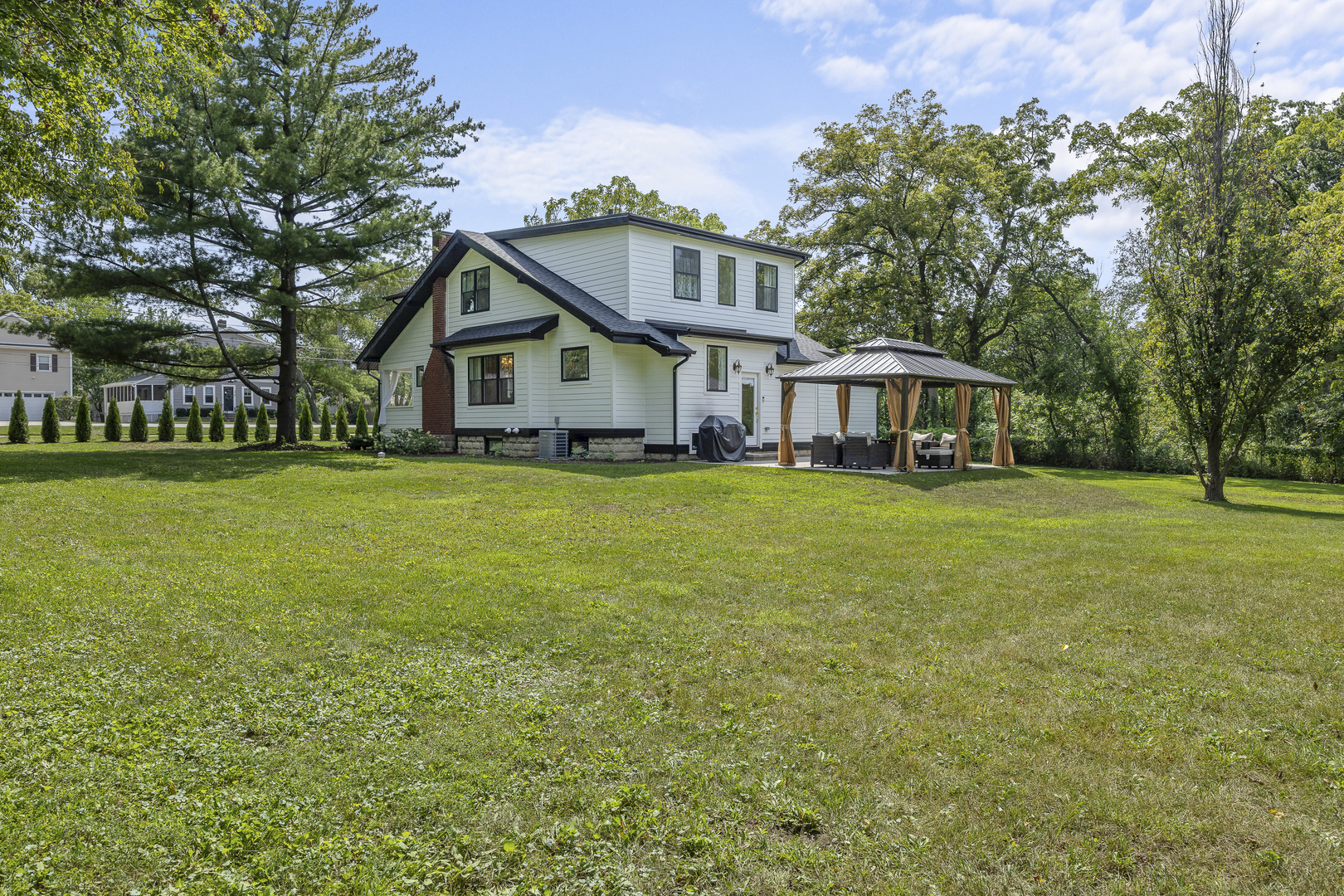 300 Geneva Road Glen Ellyn, IL 60137 - Photo 37 of 41 a view of a house with a big yard and large trees