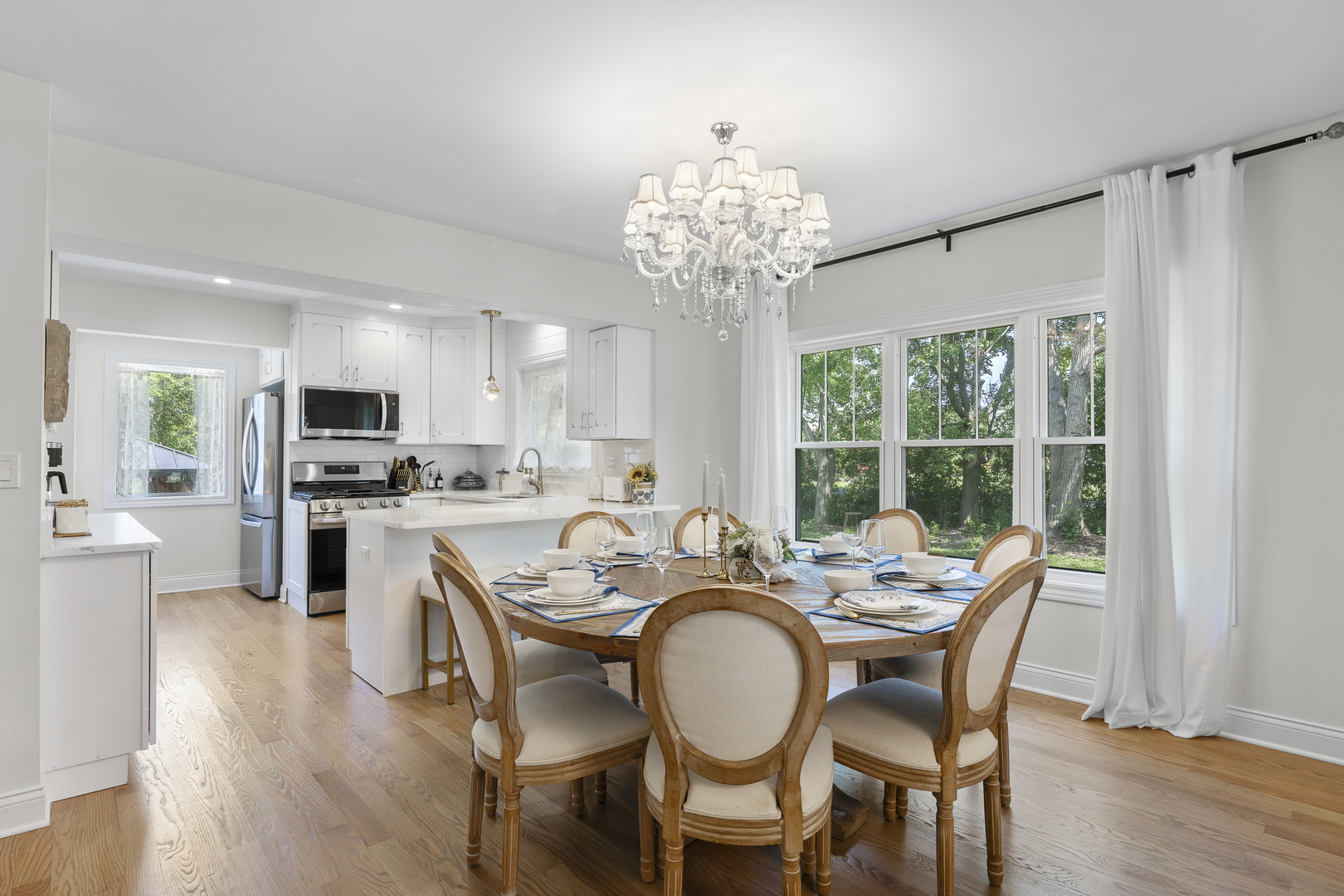 300 Geneva Road Glen Ellyn, IL 60137 - Photo 9 of 41 a view of a dining room with furniture a chandelier and wooden floor