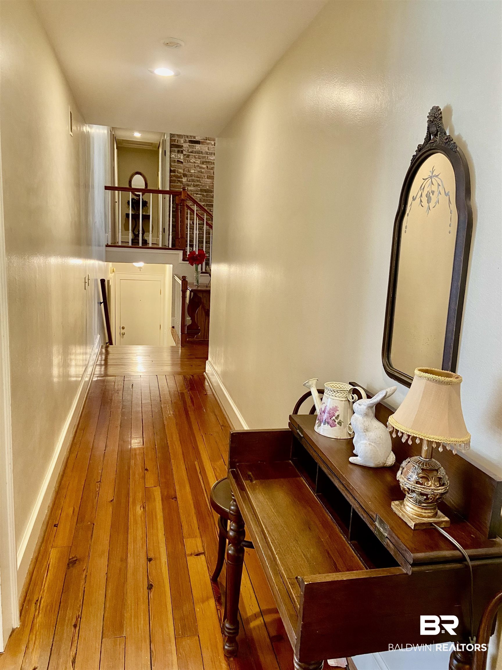 272 Longleaf Circle Monroeville, AL 36460 - Photo 16 of 38 Hallway corridor with hardwood / wood-style floors, leading to the foyer.