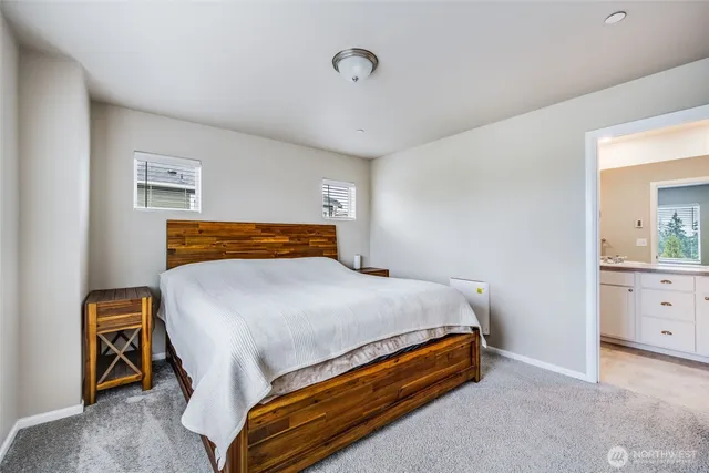 a bed sitting in a bedroom and dresser