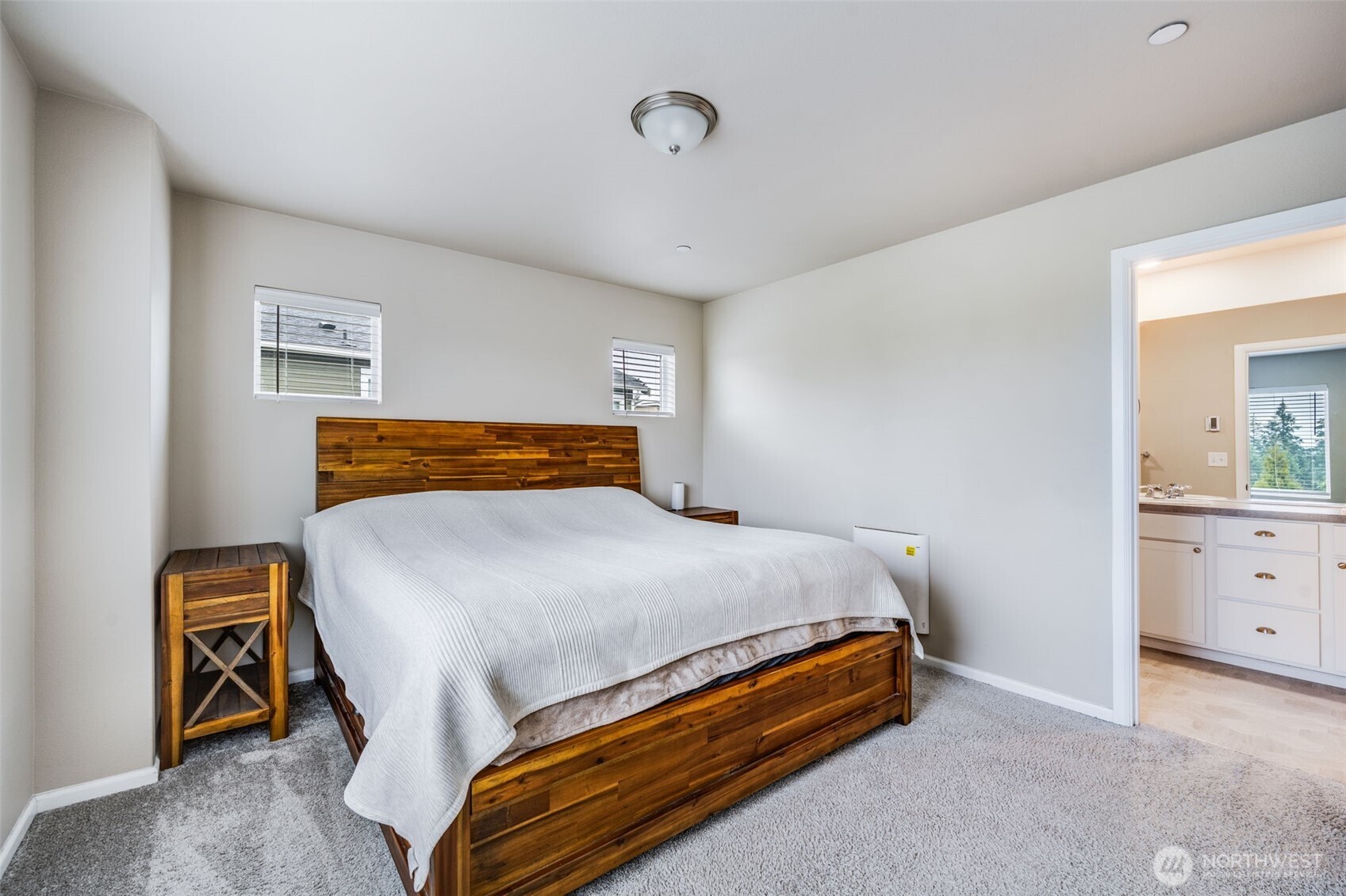 17539 110th Avenue East, Unit H Puyallup, WA 98374 - Photo 23 of 40 a bed sitting in a bedroom and dresser