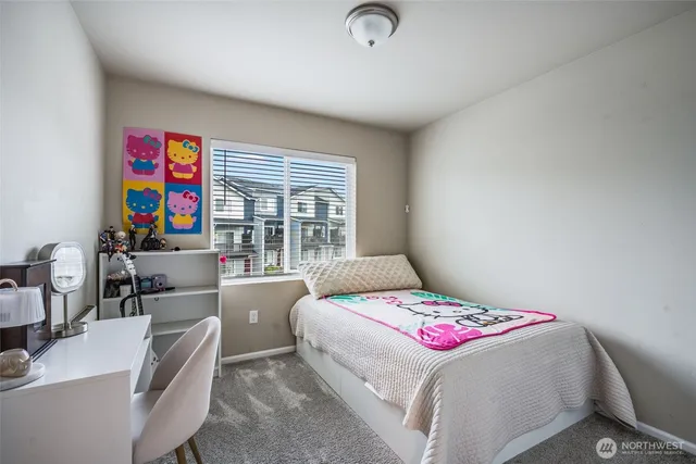 a bedroom with a bed and a desk