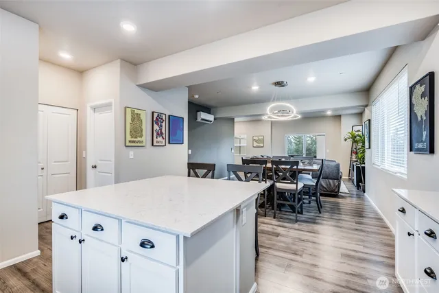 a large kitchen with lots of furniture a sink appliances dining table and chairs