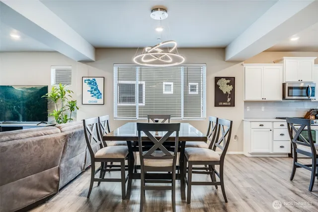 a view of a dining room with furniture and wooden floor