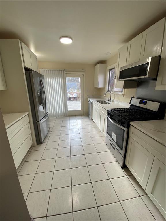 280 Old Lebanon Church Road Pittsburgh, PA 15236 - Photo 5 of 29 a kitchen with granite countertop a stove a sink and a refrigerator