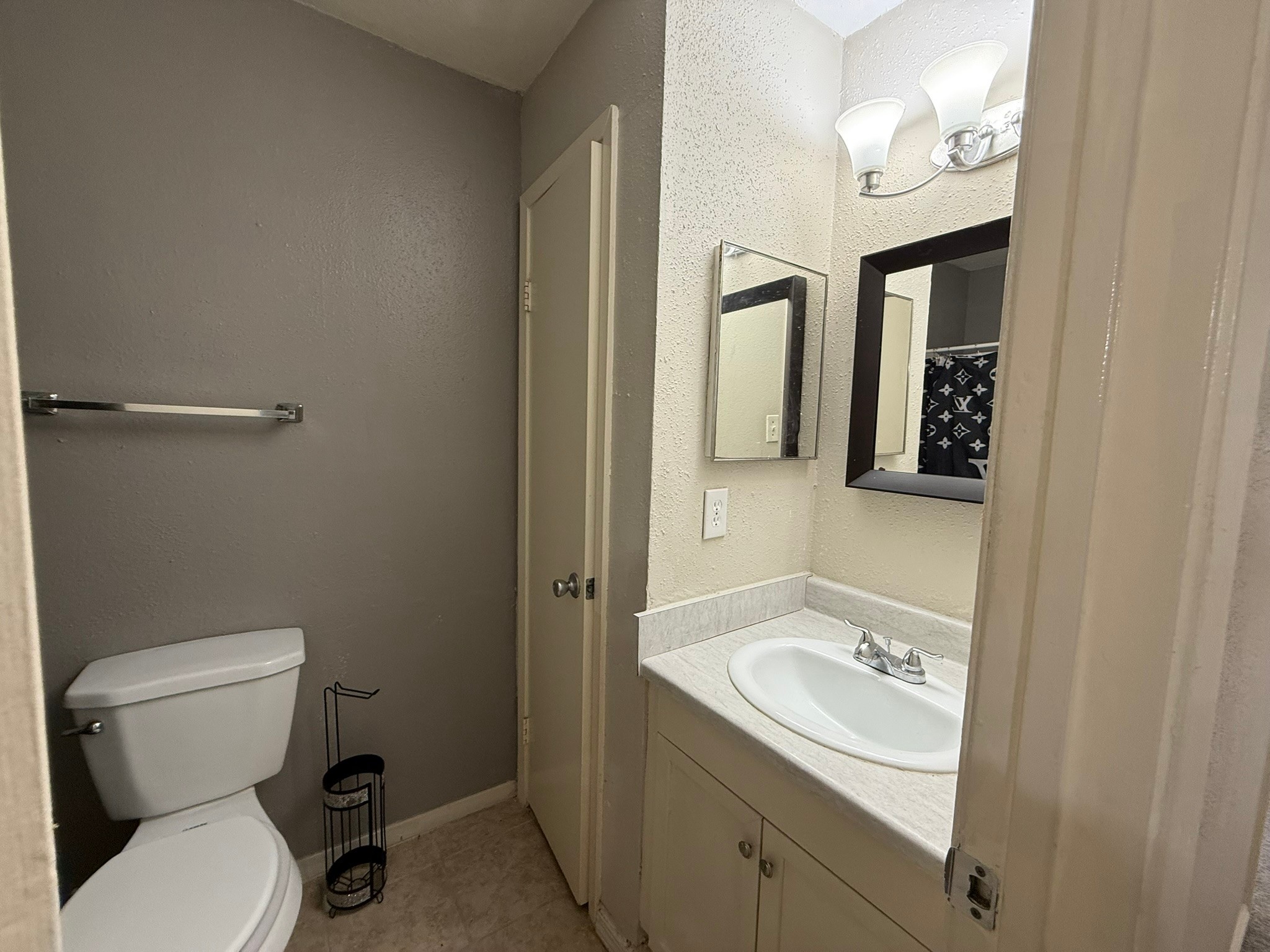 16303 Lyons School Road, Unit 315 Spring, TX 77379 - Photo 13 of 20 a bathroom with a toilet sink and mirror
