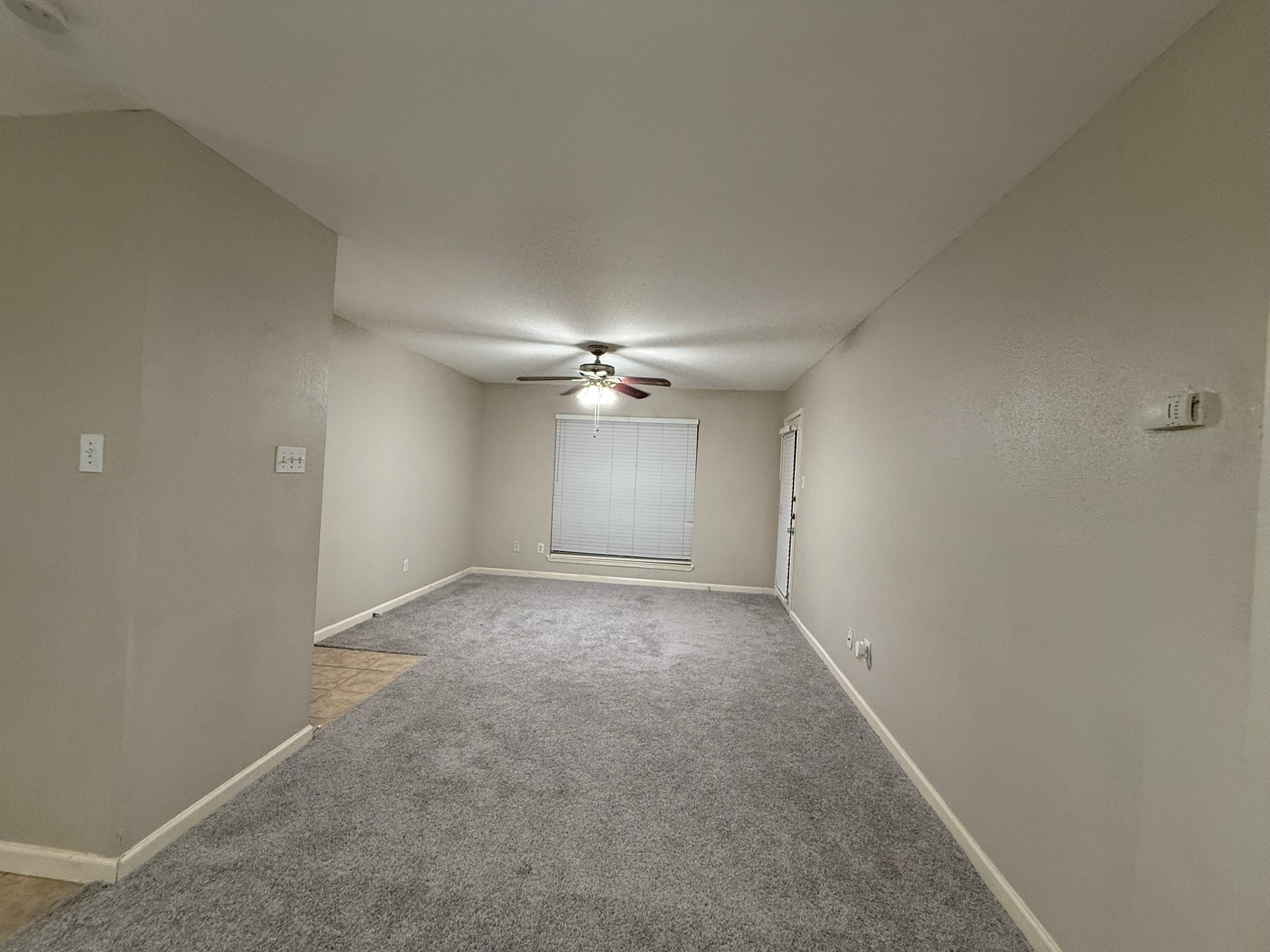 16303 Lyons School Road, Unit 315 Spring, TX 77379 - Photo 19 of 20 an empty room with a chandelier fan and windows