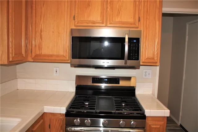 a stove top oven sitting inside of a kitchen