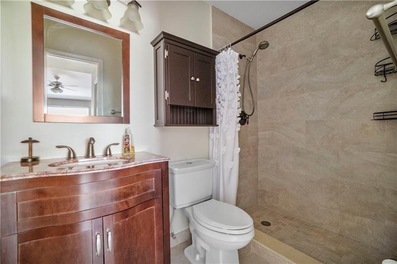 9769 Riverside Drive, Unit 712 Coral Springs, FL 33071 - Photo 13 of 18 a bathroom with a granite countertop sink toilet and shower
