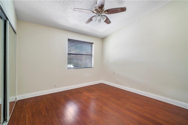 9769 Riverside Drive, Unit 712 Coral Springs, FL 33071 - Photo 14 of 18 a view of a room with wooden floor and windows