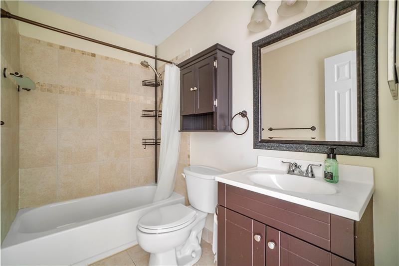 9769 Riverside Drive, Unit 712 Coral Springs, FL 33071 - Photo 15 of 18 a bathroom with a sink a toilet and a mirror