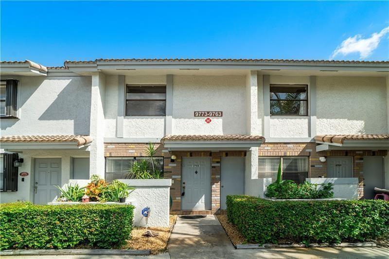 9769 Riverside Drive, Unit 712 Coral Springs, FL 33071 - Photo 2 of 18 a front view of a house with garden