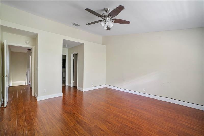 9769 Riverside Drive, Unit 712 Coral Springs, FL 33071 - Photo 10 of 18 a view of an empty room with wooden floor