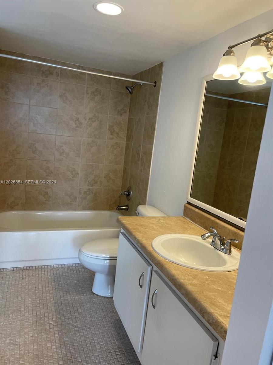 4174 Inverrary Drive, Unit 903 Lauderhill, FL 33319 - Photo 22 of 36 a bathroom with a granite countertop sink toilet and shower