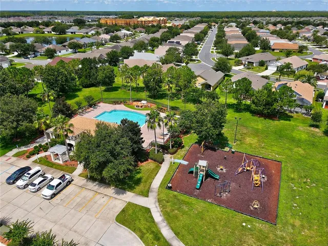 an aerial view of a house with a yard basket ball court and outdoor seating