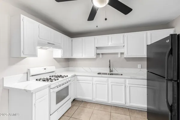 a kitchen with white cabinets and white appliances