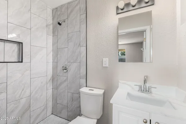 a bathroom with a sink toilet and shower