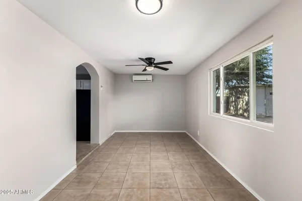 an empty room with windows and closet