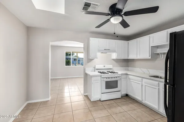 a kitchen with a stove cabinets and white appliances