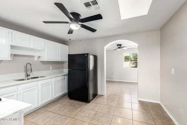 a kitchen with a refrigerator a sink and cabinets