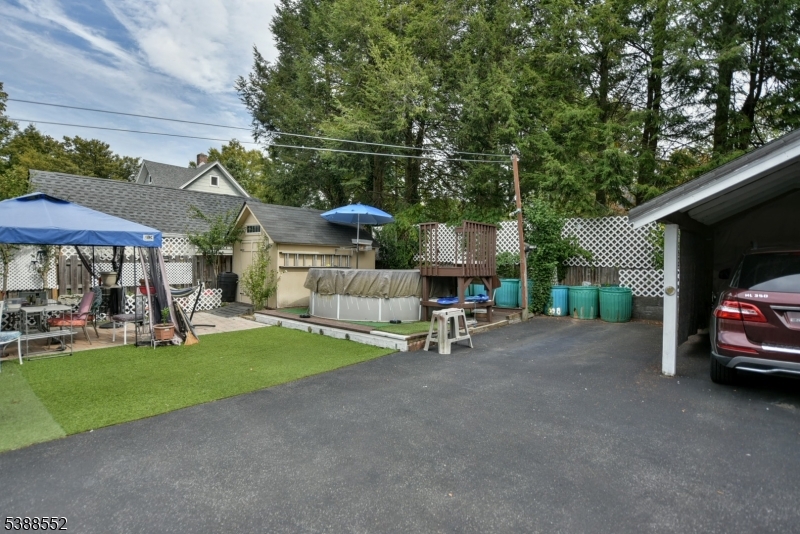 435 Northern Parkway Ridgewood, NJ 07450 - Photo 20 of 22 a view of a patio with table and chairs under an umbrella with a small yard