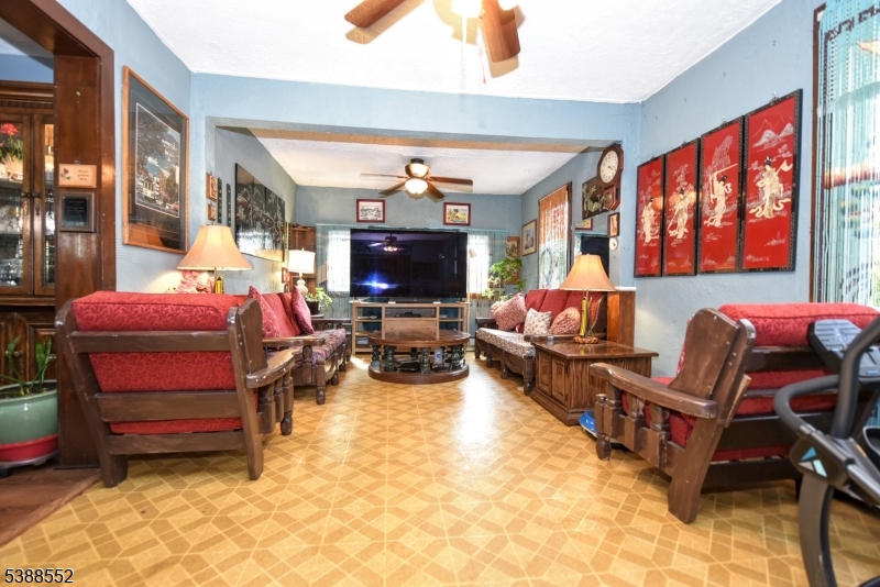 435 Northern Parkway Ridgewood, NJ 07450 - Photo 3 of 22 a living room with furniture a flat screen tv and large windows