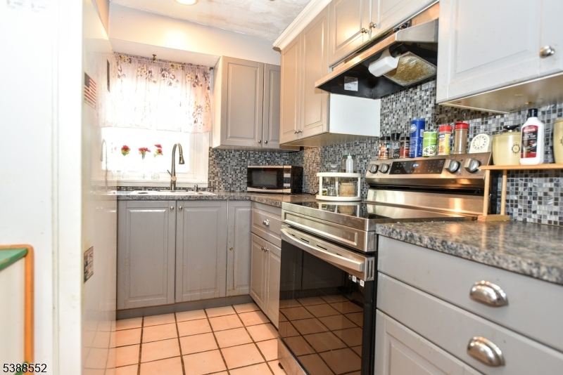 435 Northern Parkway Ridgewood, NJ 07450 - Photo 6 of 22 a kitchen with stainless steel appliances granite countertop a sink and a stove