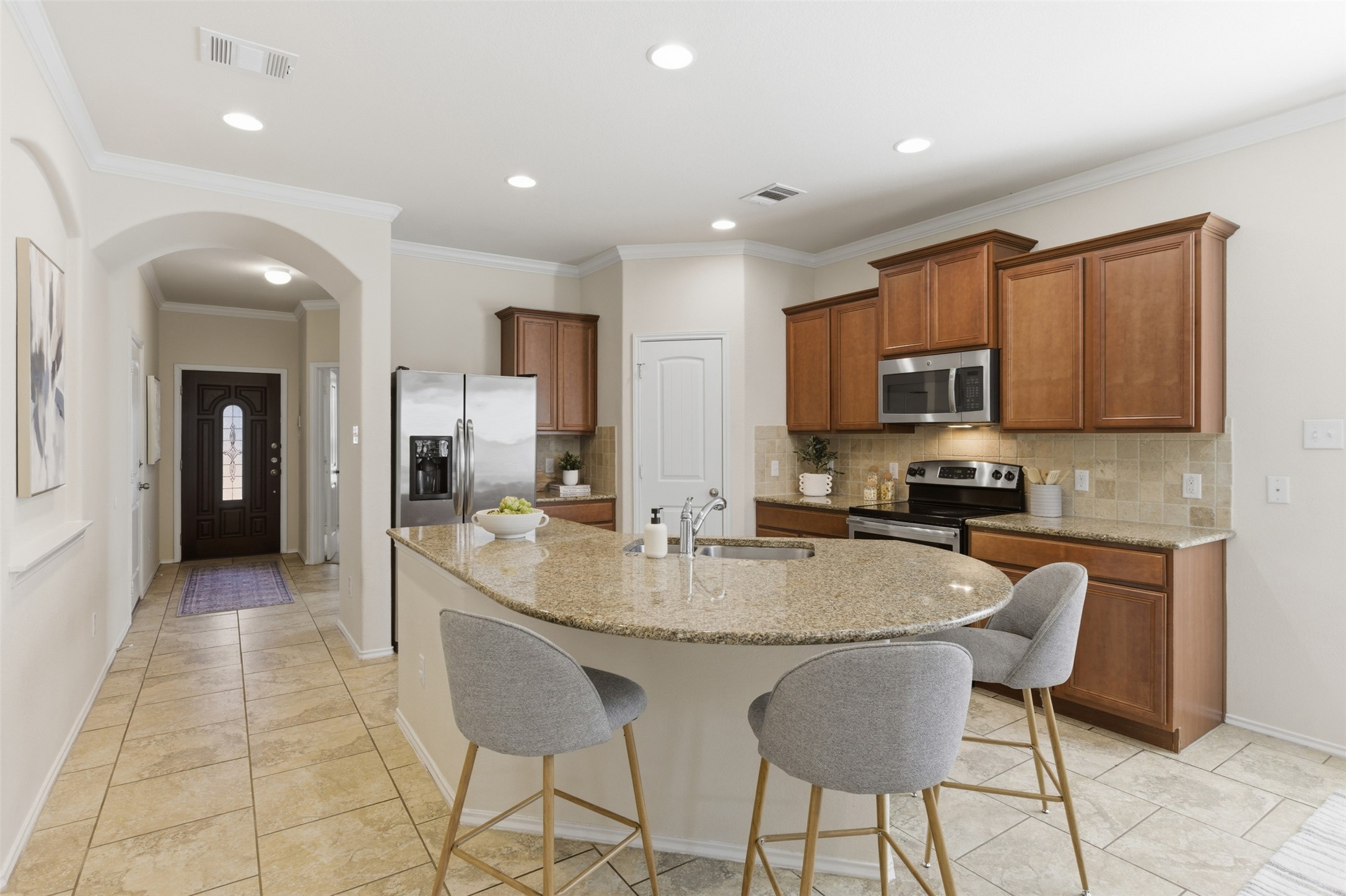 124 Golden Eagle Leander, TX 78641 - Photo 2 of 32 The kitchen with central island and seating is your hub for gatherings.