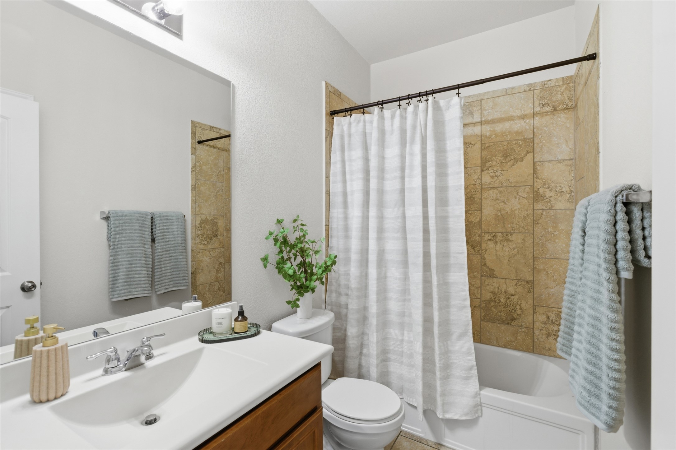 124 Golden Eagle Leander, TX 78641 - Photo 24 of 32 The secondary bathroom with large countertop, tiled shower.