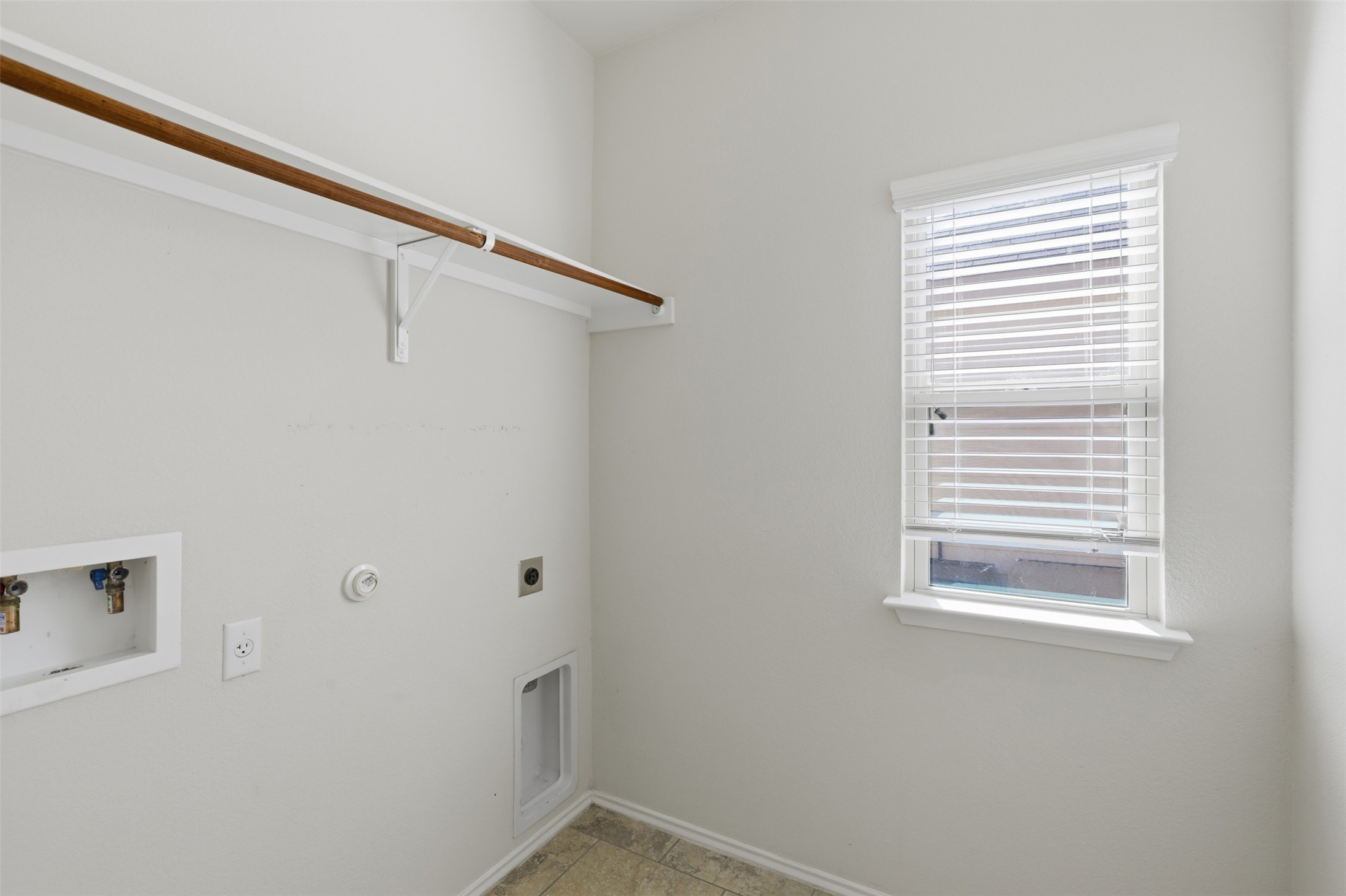 124 Golden Eagle Leander, TX 78641 - Photo 27 of 32 The utility room is at the front of the home with a window!