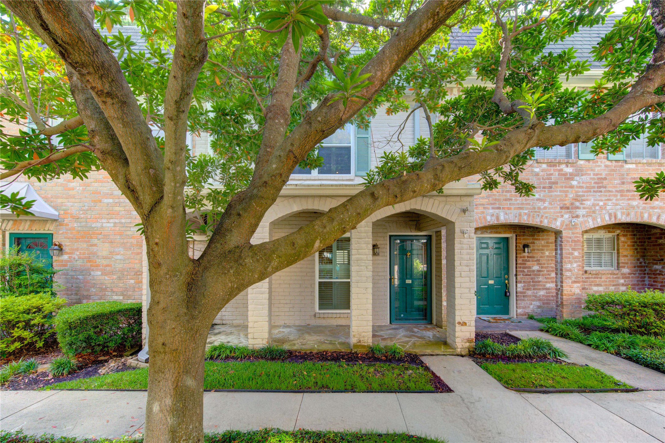 2232 South Piney Point Road, Unit 110 Houston, TX 77063 - Photo 17 of 21 Inviting front entrance surrounded by mature landscaping and charming architectural details that create exceptional curb appeal.