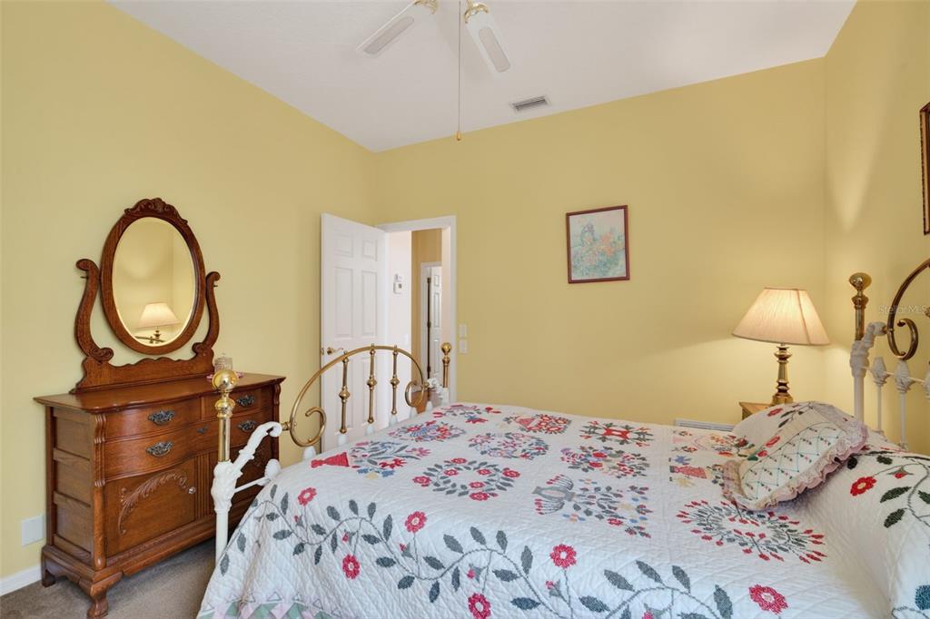 4266 Summertree Road Venice, FL 34293 - Photo 24 of 64 a bedroom with a bed and a chandelier