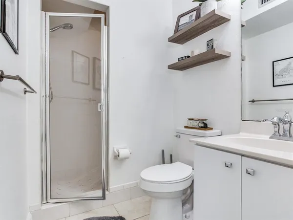 a bathroom with a sink mirror and toilet