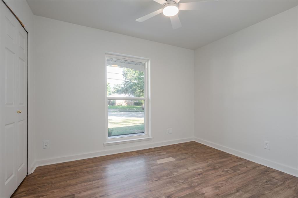 1807 North Waterview Drive Richardson, TX 75080 - Photo 20 of 26 an empty room with wooden floor and windows
