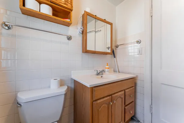 a bathroom with a sink toilet and mirror