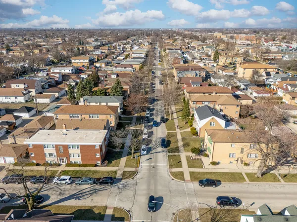 an aerial view of residential houses with city view