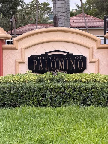 a view of a kitchen with a sink and a refrigerator